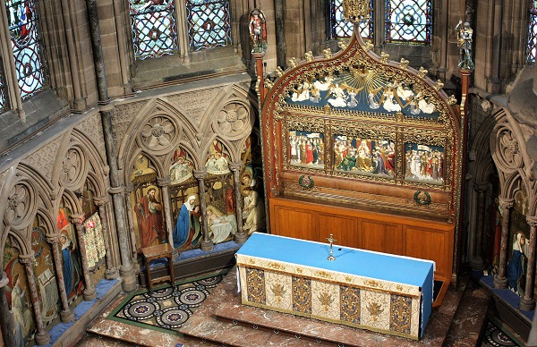 The St Mary the Virgin parish church chancel decoration includes oil on copper panels in niches, a reredos designed by J Harold Gibbons of Westminster and constructed by Boulton and Sons of Cheltenham and Minton floor tiles.